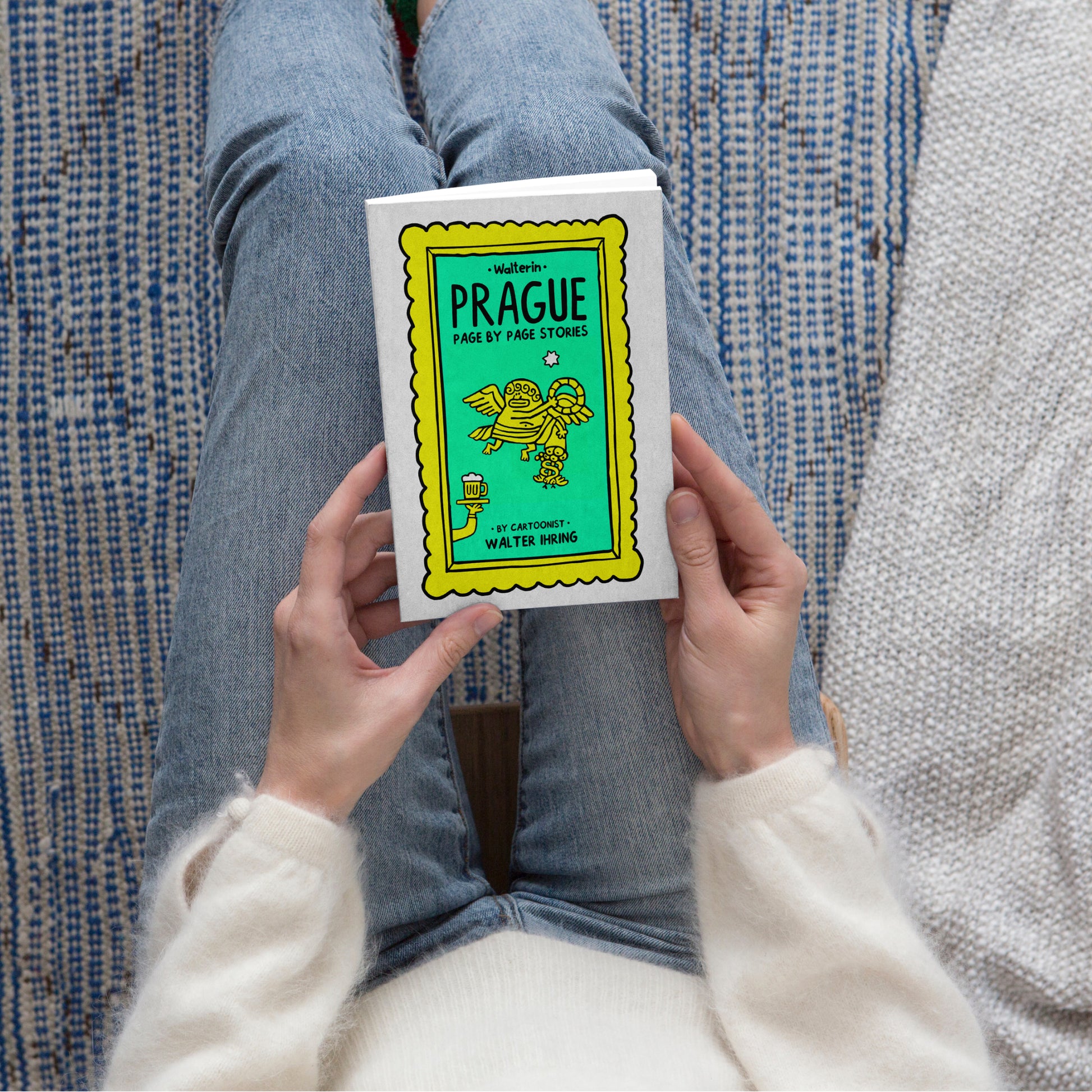 Person holding the Walterin Prague illustrated comic guide book featuring witty cultural stories