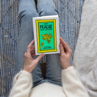 Person holding the Walterin Prague illustrated comic guide book featuring witty cultural stories